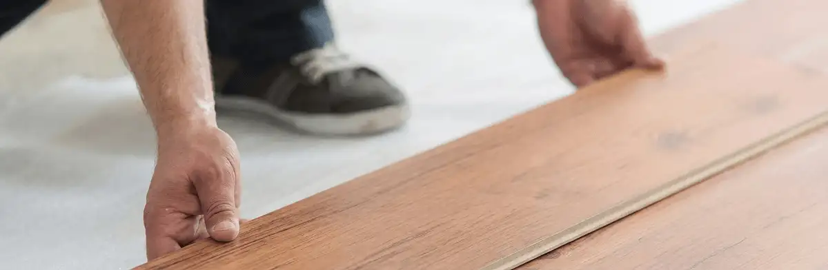 A professional installing laminate flooring in Lincoln, NE